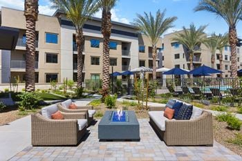 Outdoor courtyard with ramadas, lounge seating, fire pits, yard games, and gourmet grilling stations